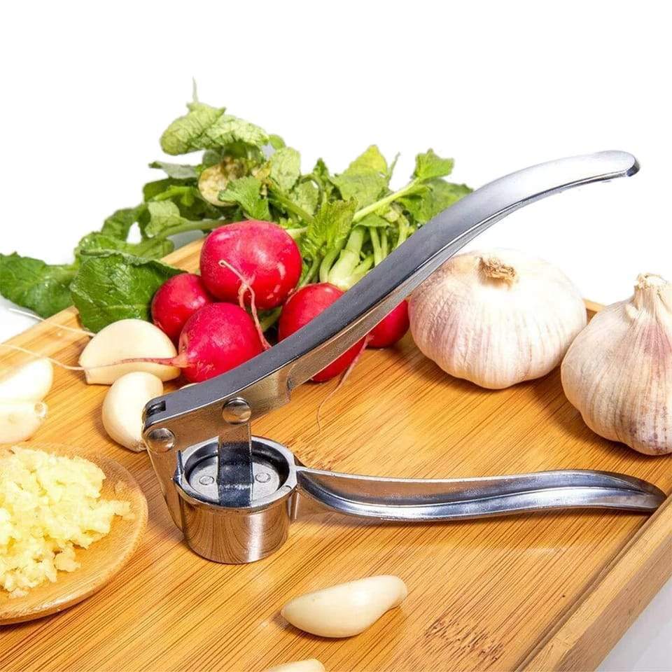 Close-up of stainless steel garlic press with textured handle