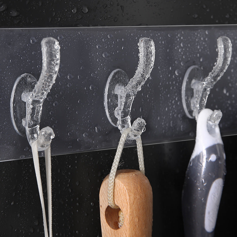 Transparent adhesive wall hook mounted on a surface